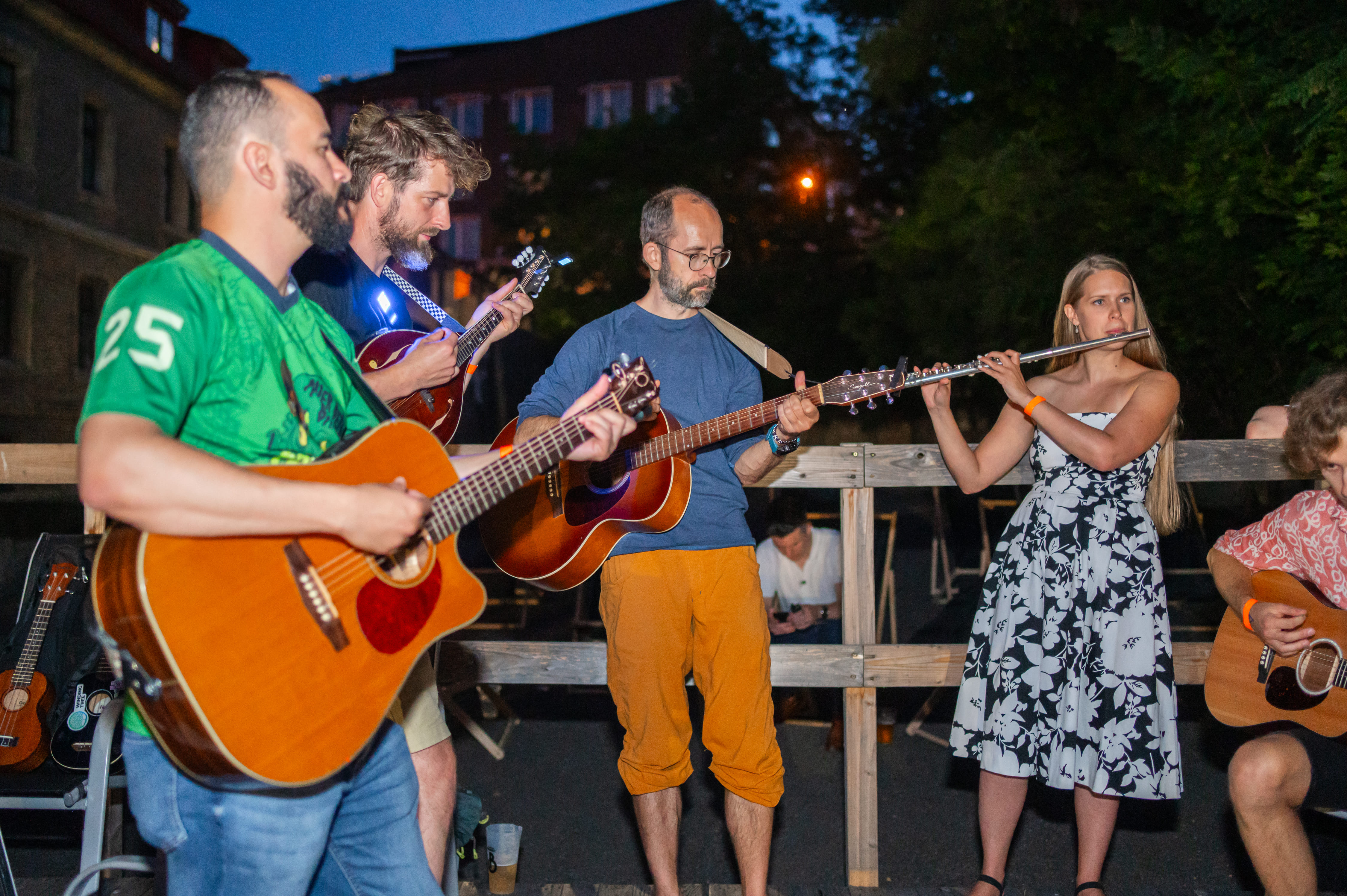 People playing music together in an outdoor jam session